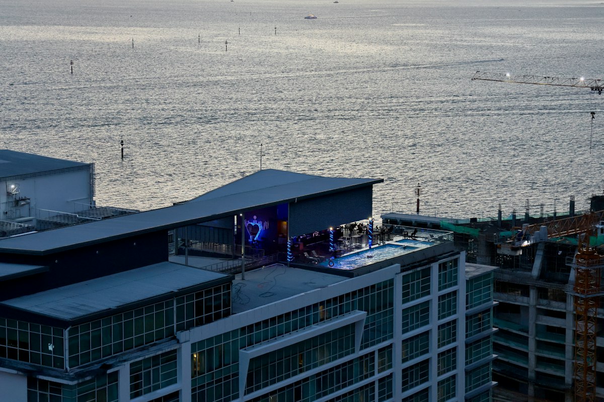 Rooftop bar and pool overlooking the sea at dusk (illustrative photo)