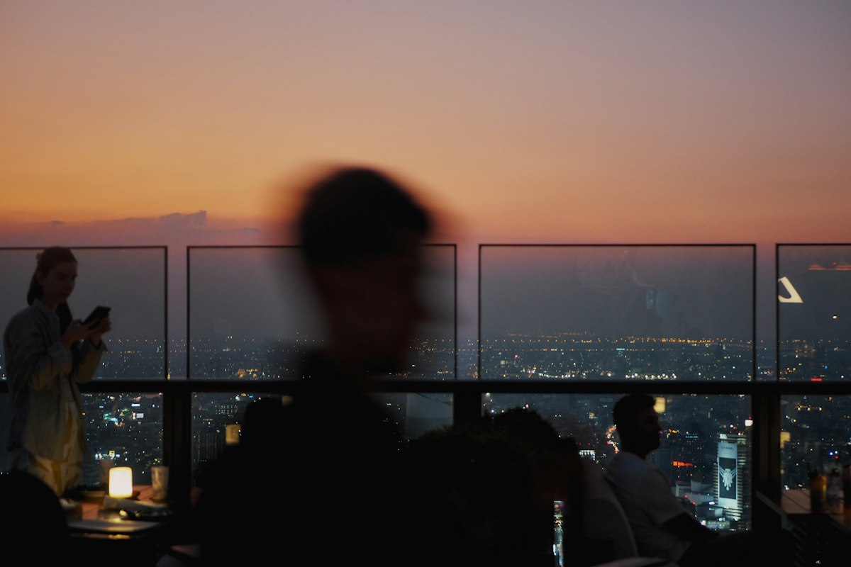 City skyline at sunset from a rooftop bar (illustrative photo)