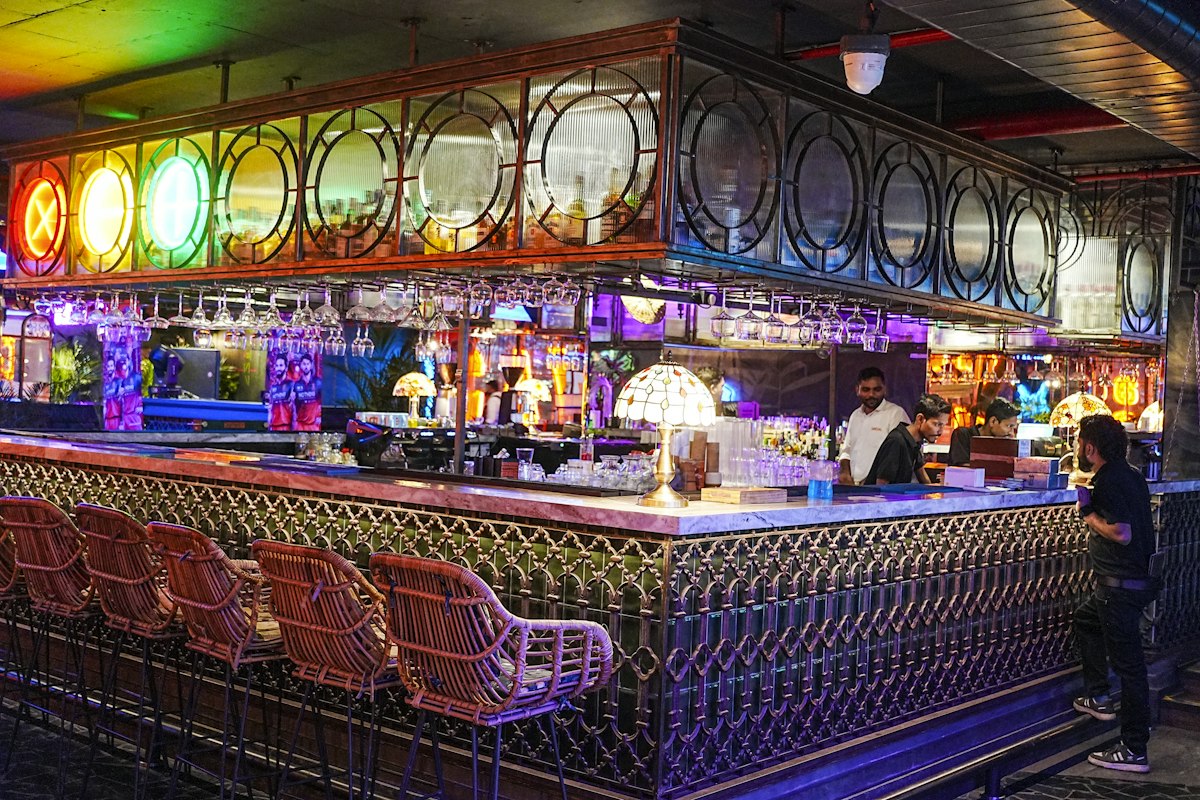 Colourful bar interior with people and evening lights (illustrative photo)