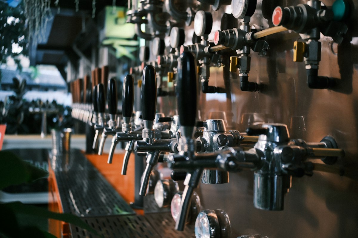 Row of craft beer taps along a bar (illustrative photo)